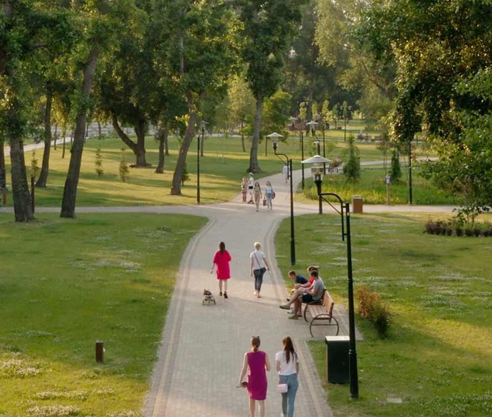 People walking around a park in a city