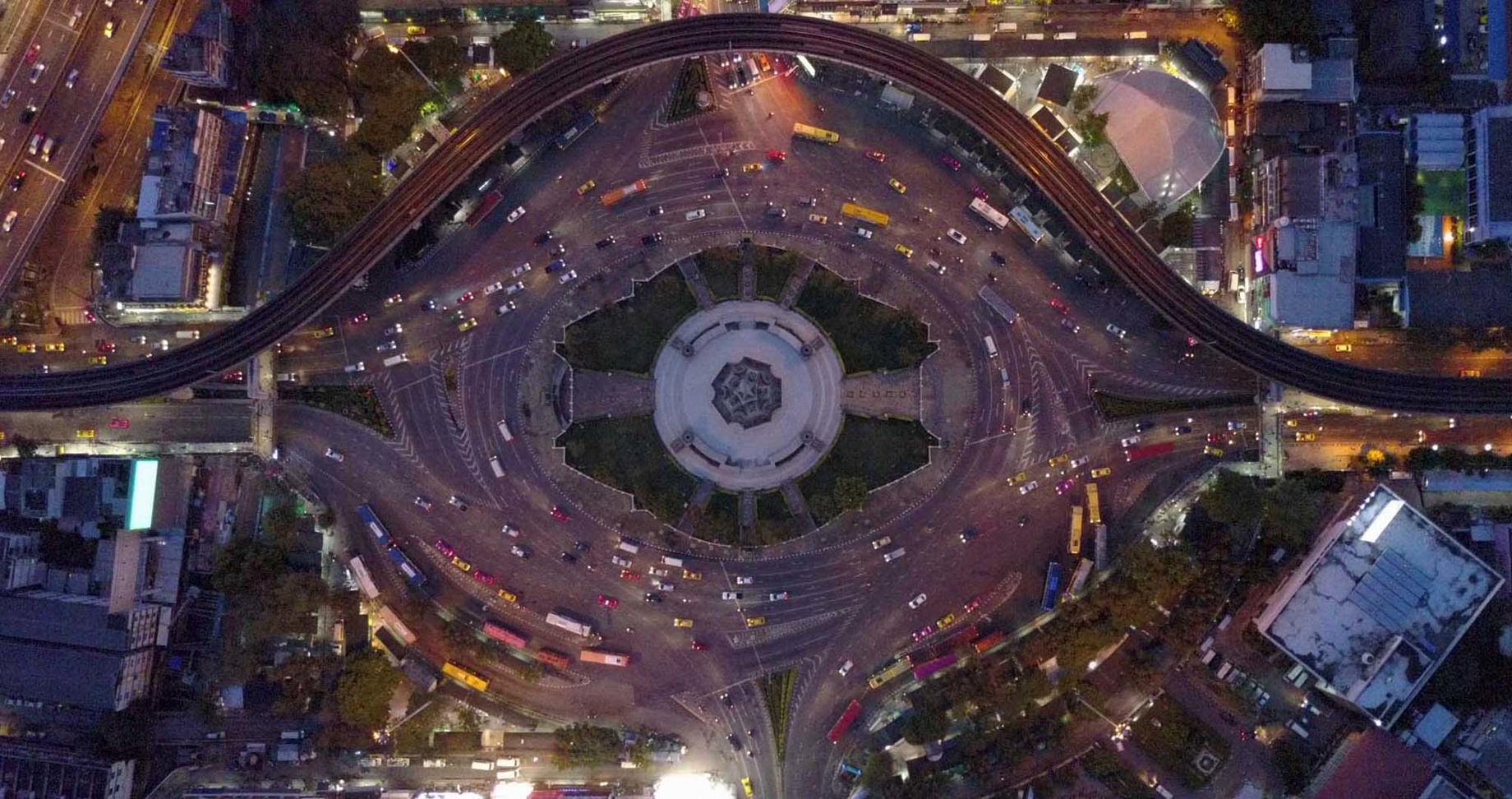 A birds-eye view of a large, busy roundabout in a city