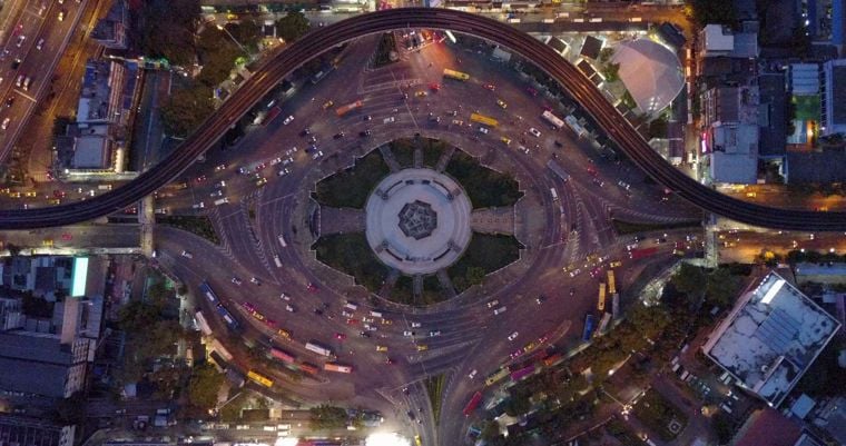 A birds-eye view of a large, busy roundabout in a city