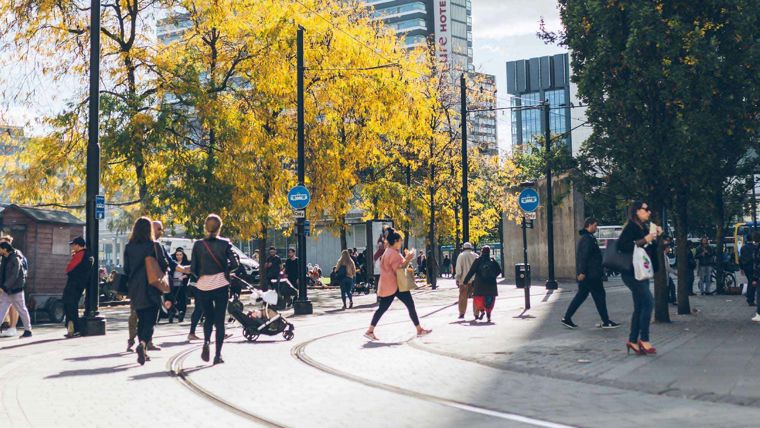 People walking through a city in the north of England