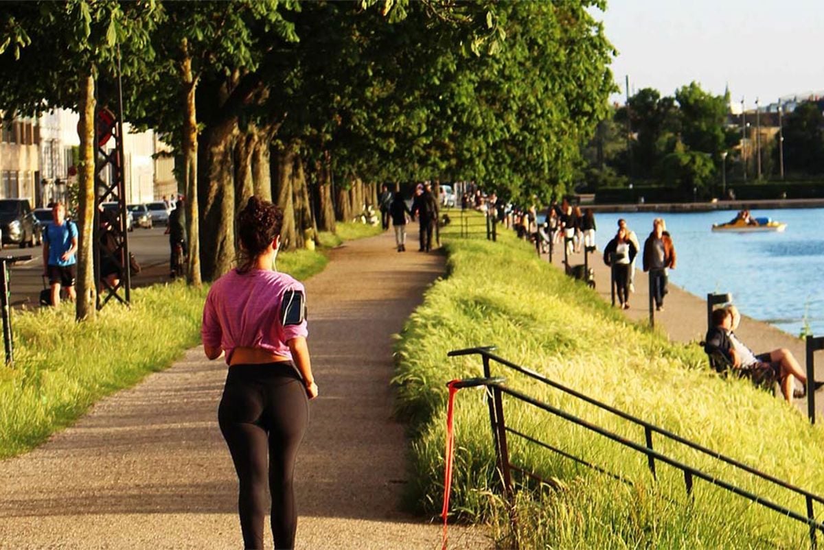 Women running alongside a river