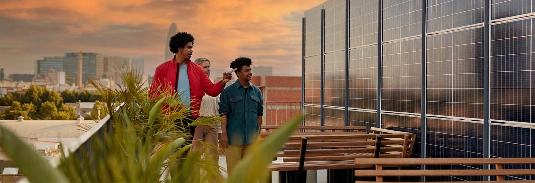 People on a rooftop looking at solar panels