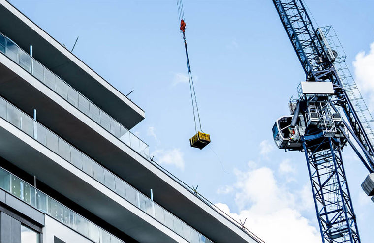 A crane carrying out construction work on a tall building