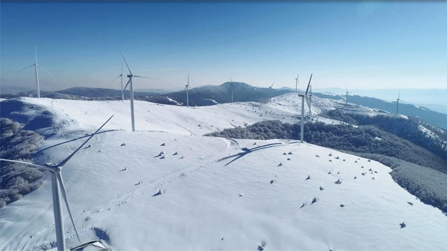 Wind turbines on a mountain in the snow