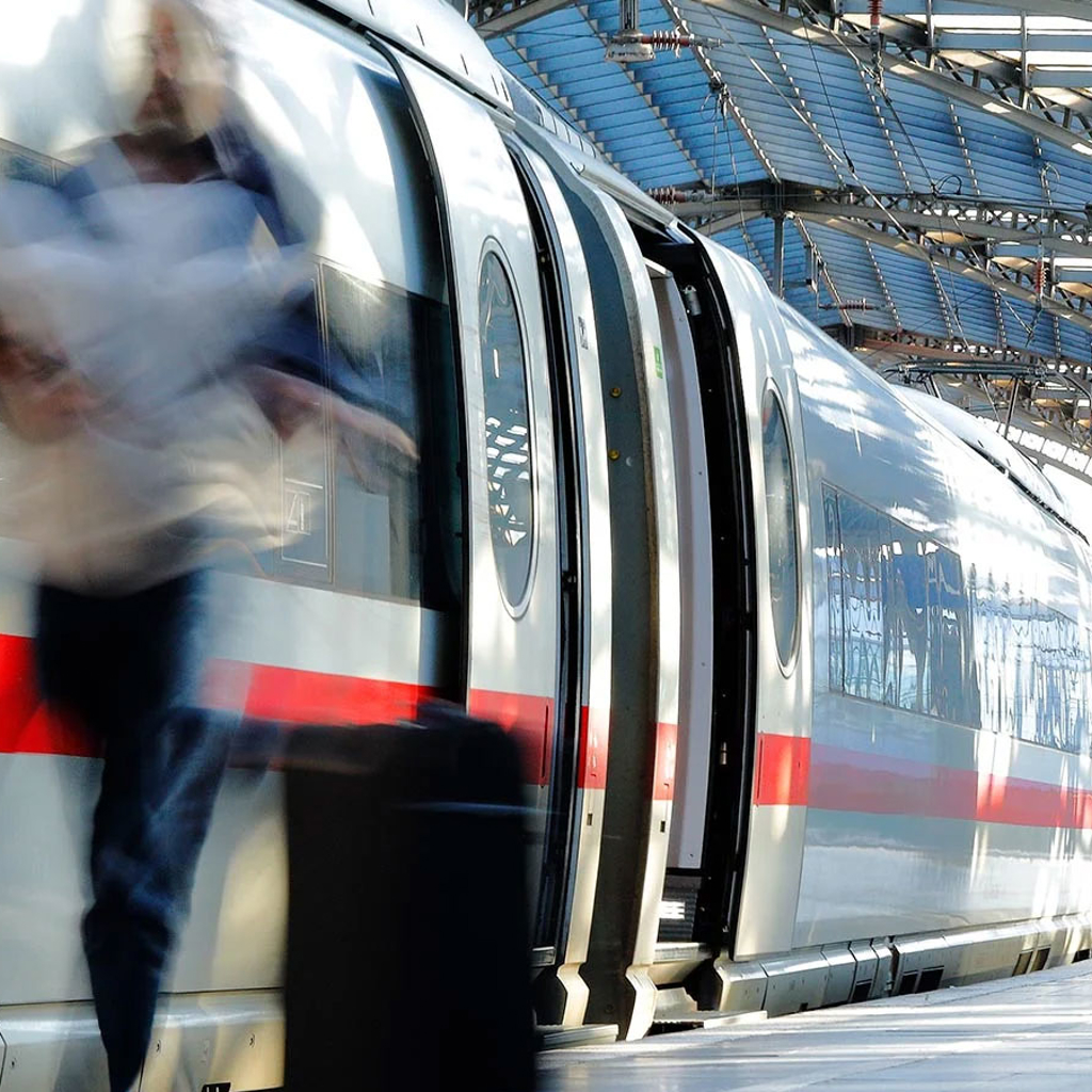 Train at a station with passengers on the platform