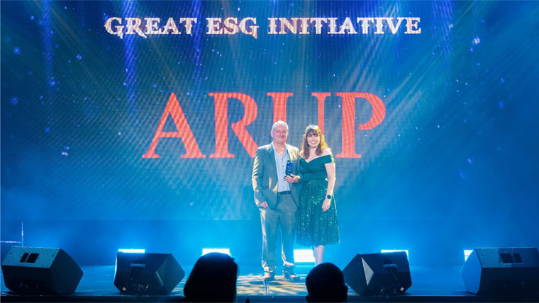 Neal Harvey and colleague receive the award on Arup's behalf