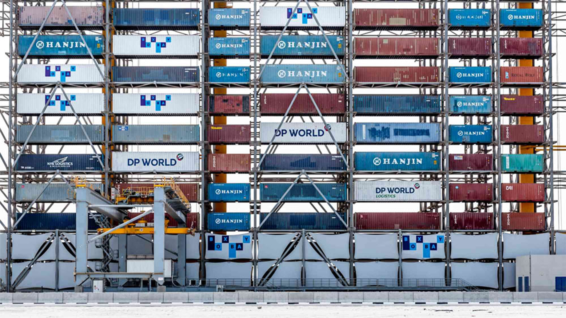 Shipping containers sit at a port