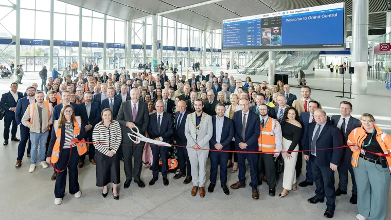 People attending a ribbon cutting opening ceremony at Belfast Grand Central Station