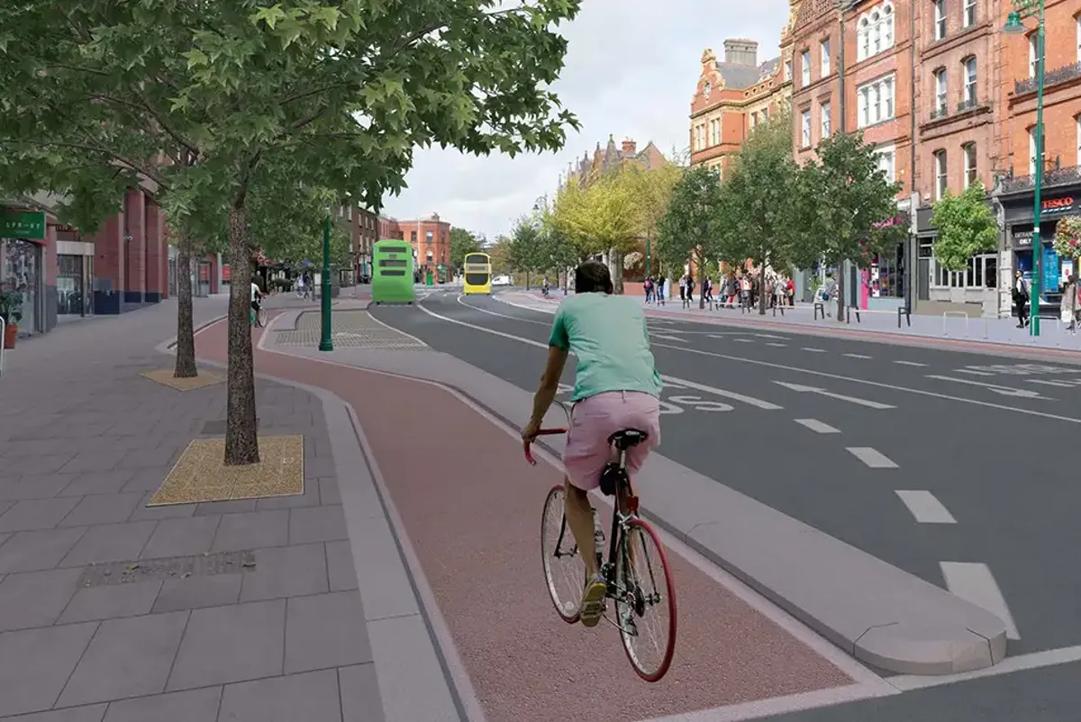 Visualisation of the proposed Belfield/Blackrock to City Centre scheme, showing a cyclist, buses and pedestrians.