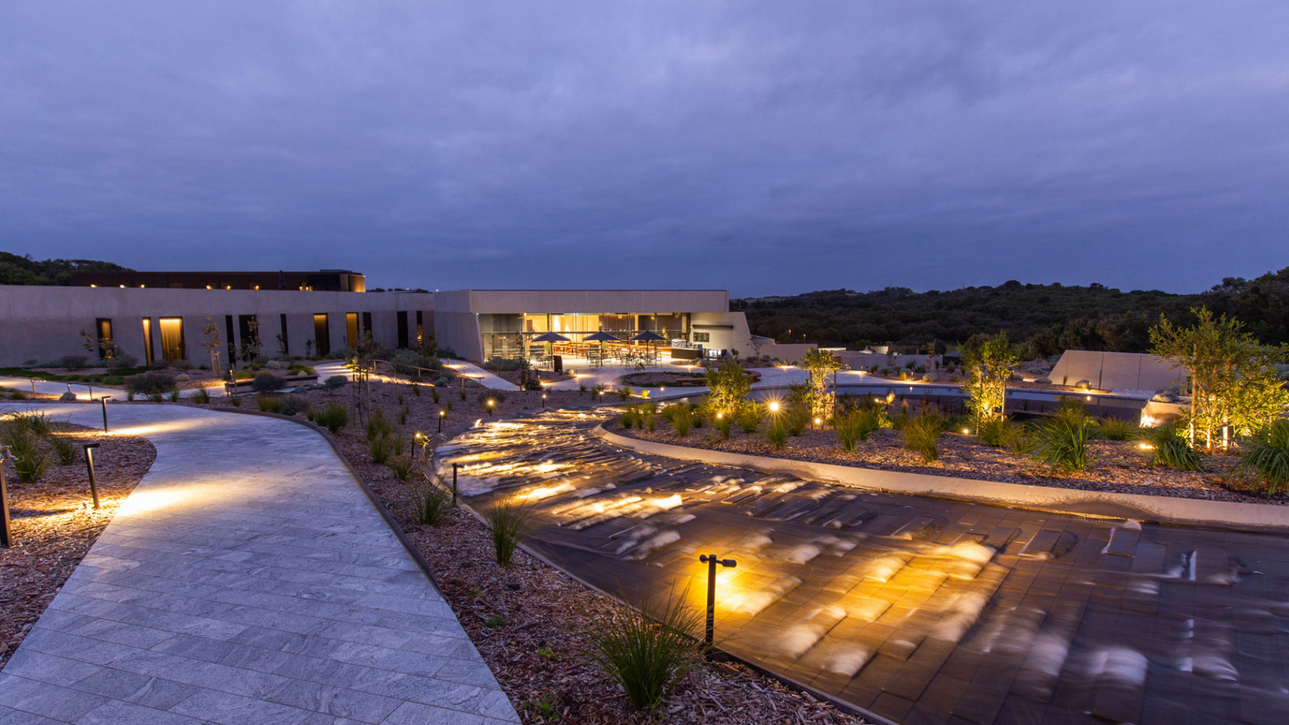 Outdoor water features and foot paths with lighting at dusk