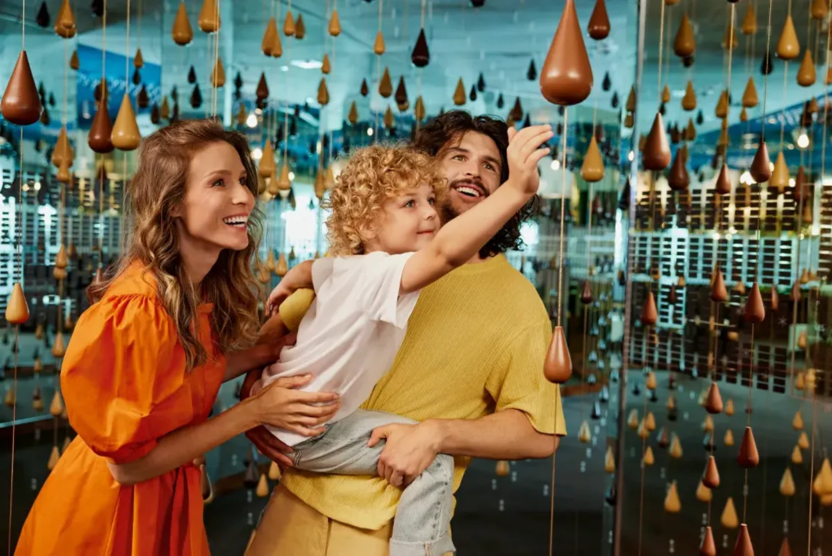 A family interacting with a display in a chocolate museum