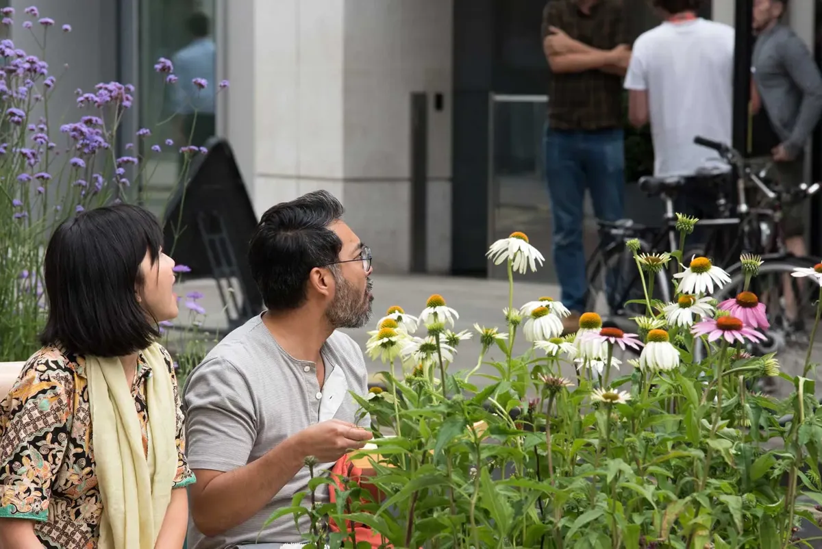 Two people eating lunch on a parklet