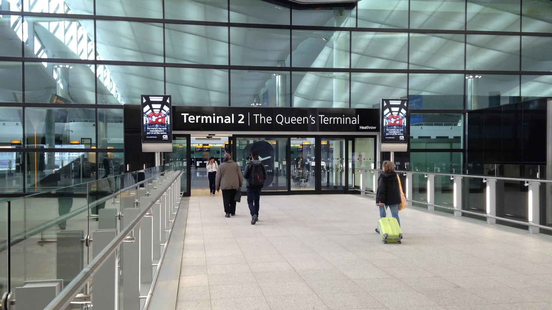 Passengers approaching the entrance of Terminal 2 at Heathrow Airport