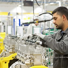 A man using machinery inside the JLR manufacturing facility