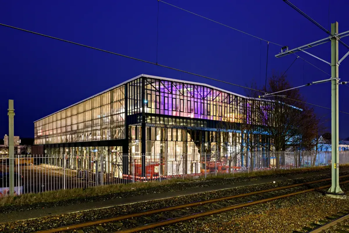 Exterior view of a large industrial building at nightime