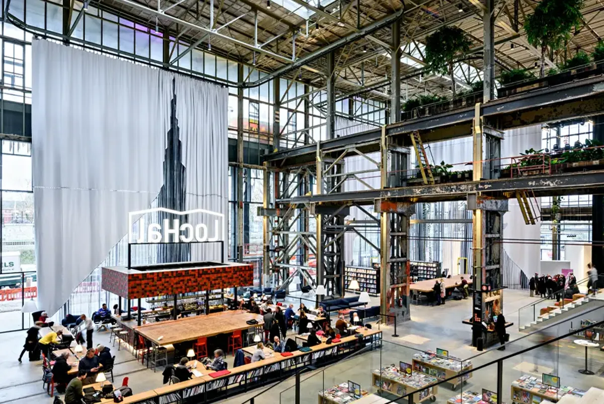 People seated inside LocHal, a large industrial building