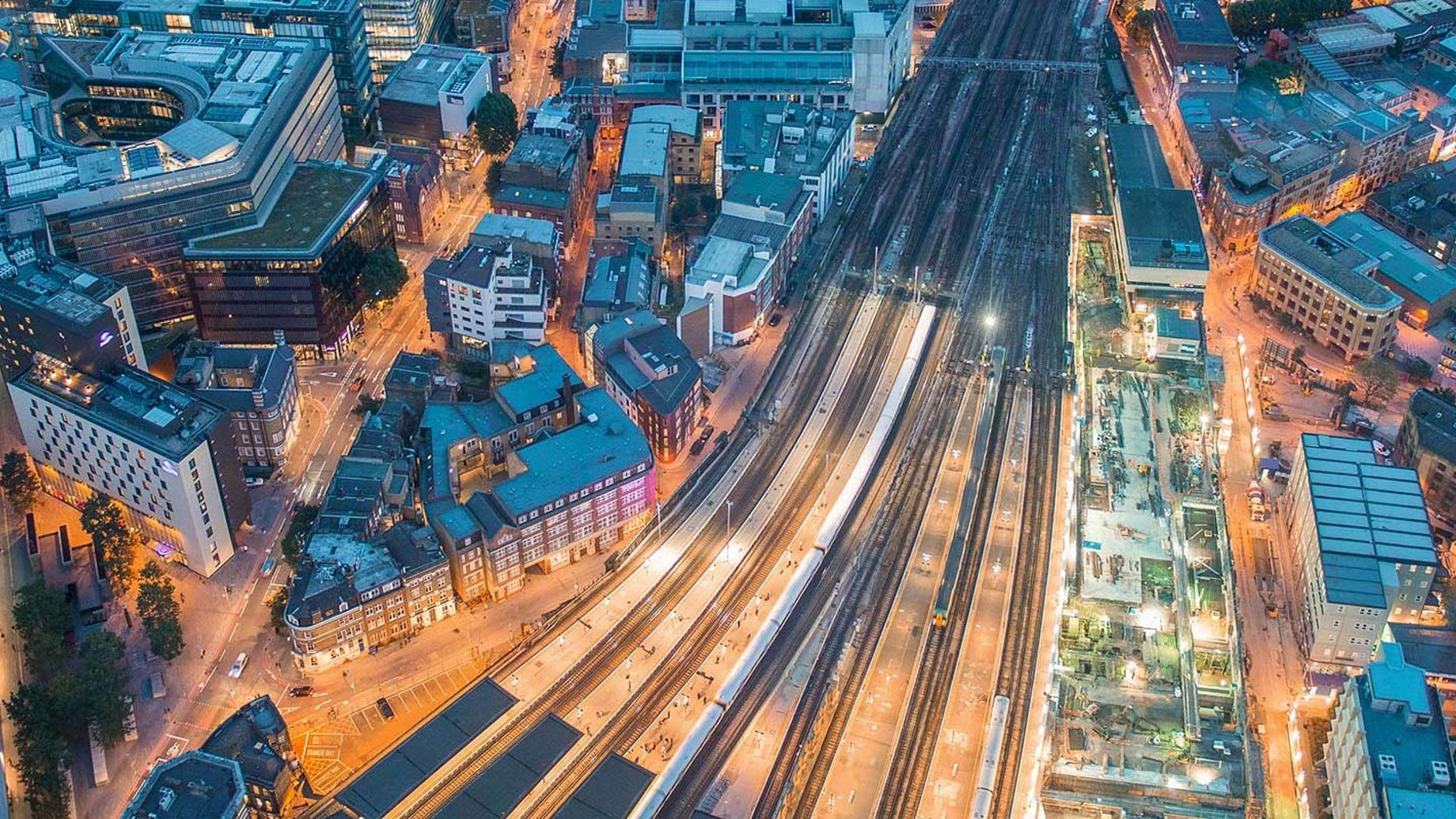 Aerial view of tracks approaching London Bridge station at night