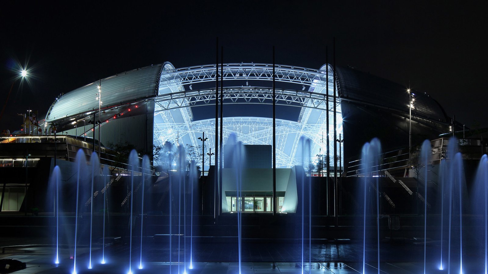 Singapore Sports Hub at night with fountains in the foreground