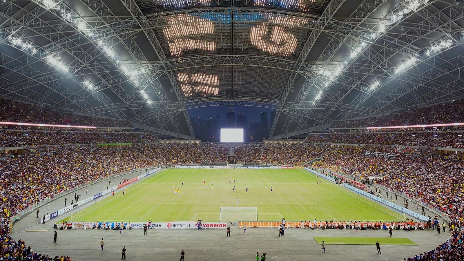 Singapore Stadium hosting football with the roof open