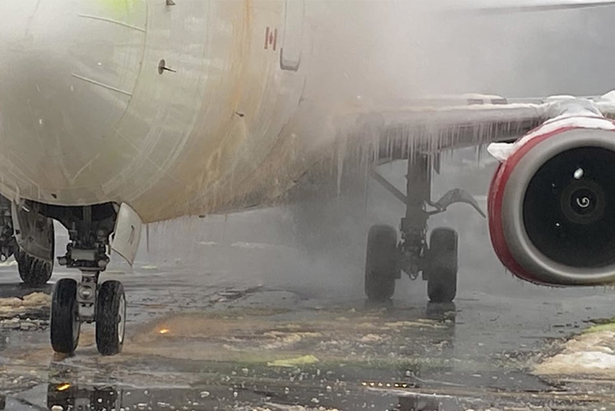 Heavily iced plane at an airport