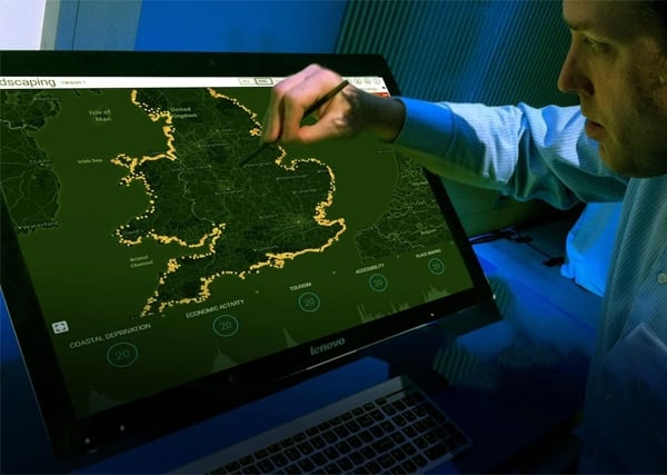 Man using a screen to view assets around the UK
