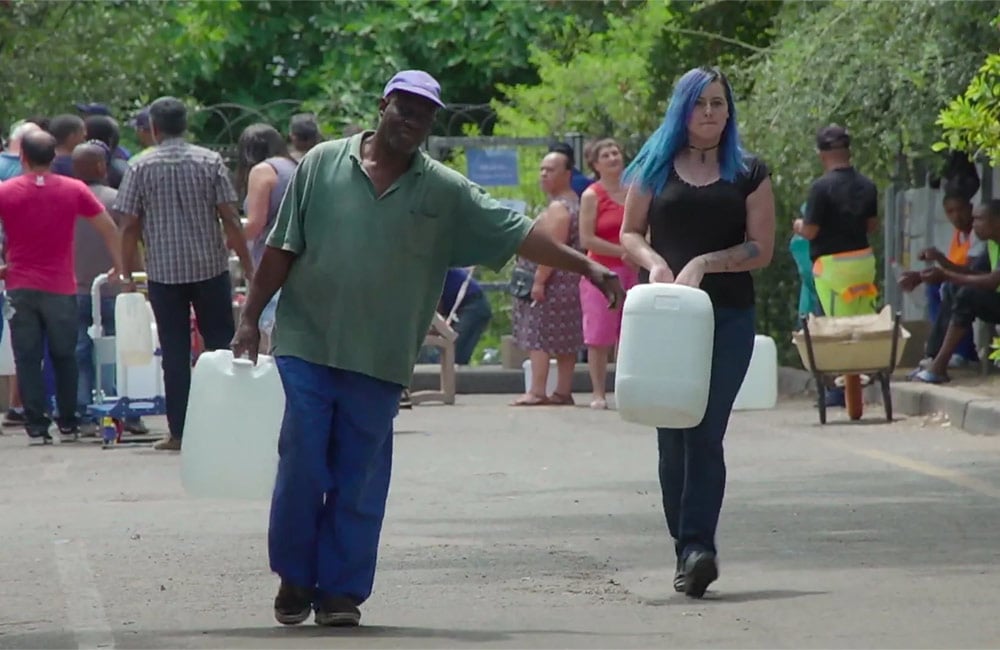 People in Cape Town carrying potted water