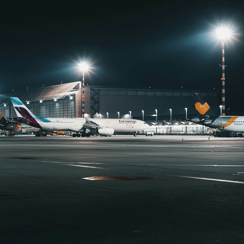 Planes at an airport at night