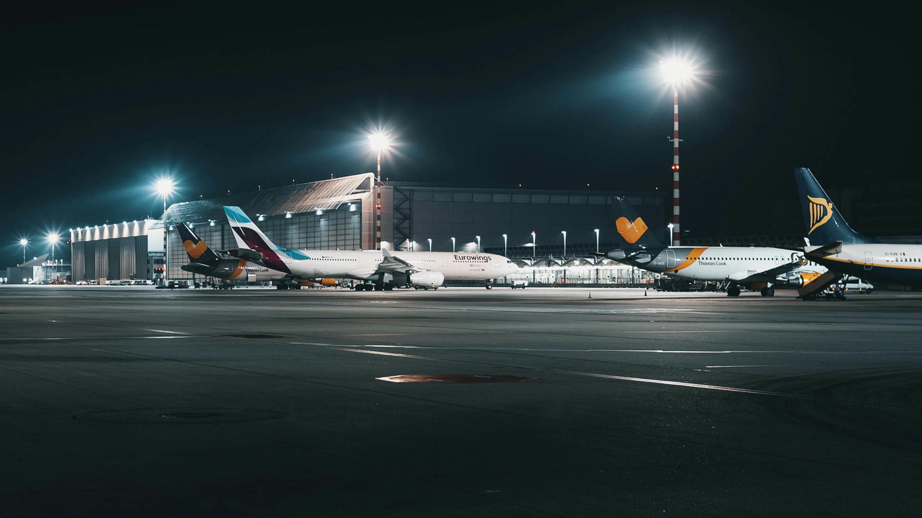 Planes at an airport at night